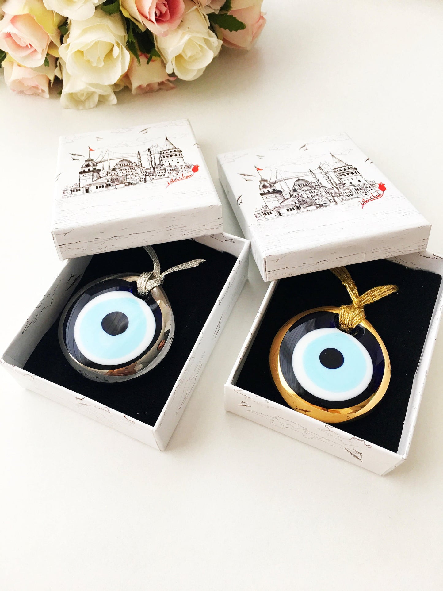 ELITE CASA Christmas gift ideas featuring blue evil eye charm in decorative boxes.