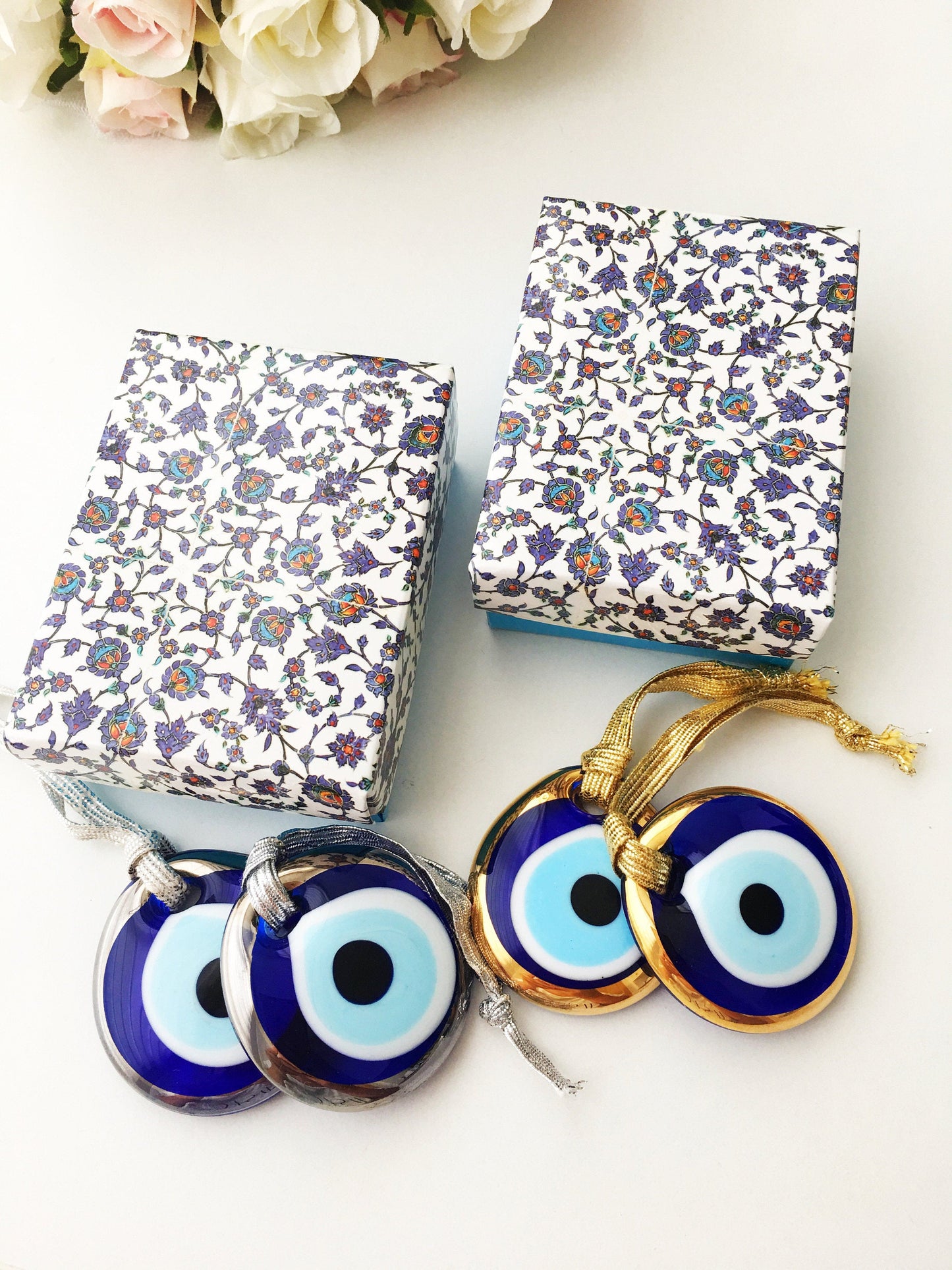 ELITE CASA Christmas gift ideas featuring blue evil eye charm in decorative boxes.