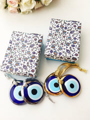 ELITE CASA Christmas gift ideas featuring blue evil eye charm in decorative boxes.