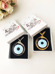 ELITE CASA Christmas gift ideas featuring blue evil eye charm in decorative boxes.