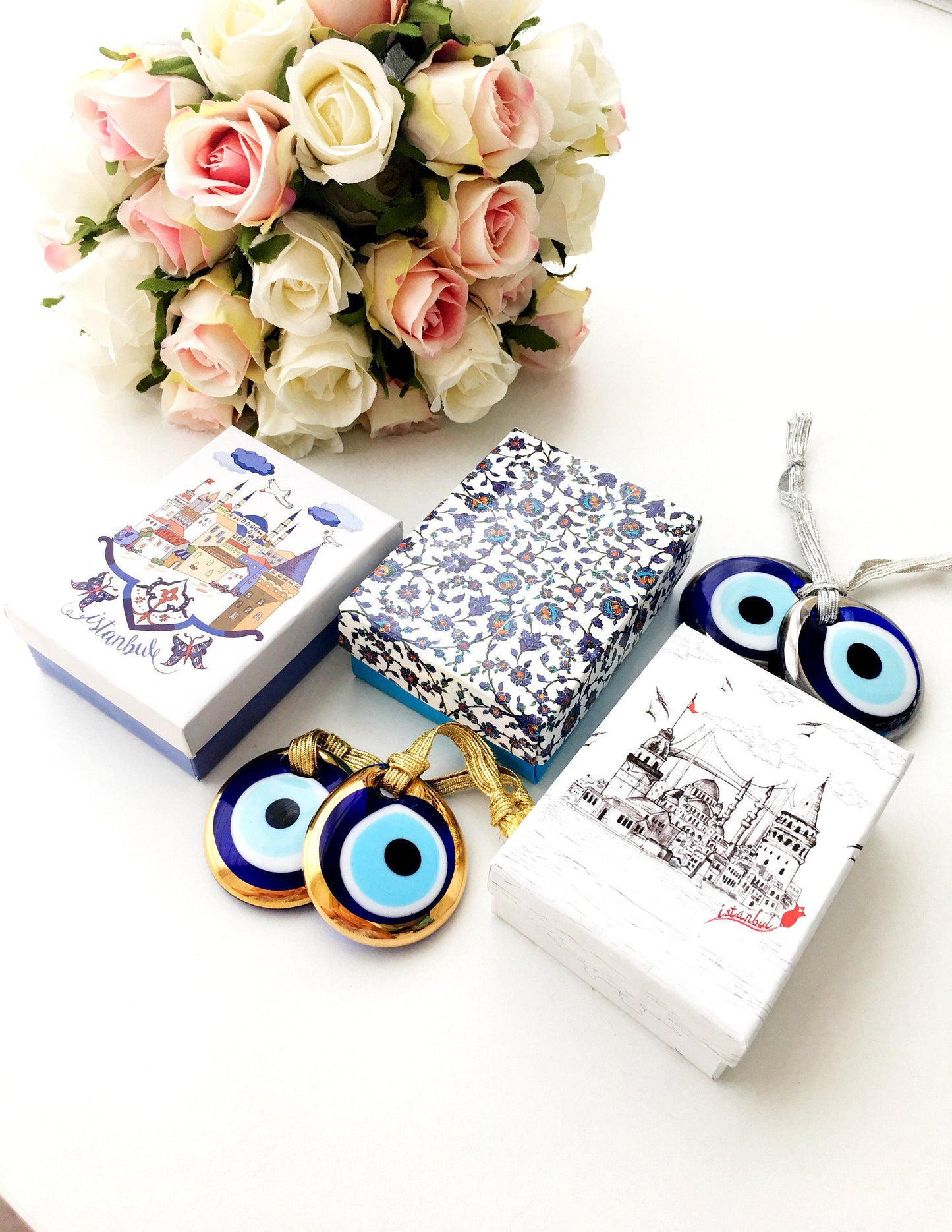 ELITE CASA Christmas gift ideas featuring blue evil eye charm in decorative boxes.